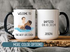 two personalized coffee mugs sitting on top of a wooden table next to a blanket