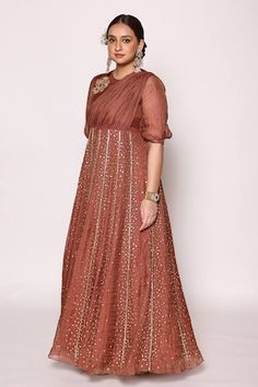 Chocolate brown three fourth puffed sleeves floor length panelled dress with front drape, 3D floral applique on shoulder and fully embellished pannels with scattered effect using dull gold diamond shaped rexin, pipes and beads embellishments. - Aza Fashions Festive Dresses With Gathered Sleeves, Fitted Dress With Gathered Sleeves For Festive Occasions, Fitted Dresses With Gathered Sleeves For Festivities, Festive Wedding Dress With Gathered Sleeves, Panelled Dress, Panel Dress, Floral Applique, Diamond Shaped, Puffed Sleeves