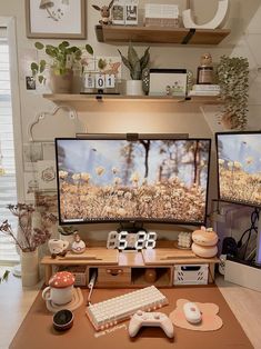 two computer monitors sitting on top of a wooden desk