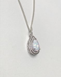 Sterling Silver White Fire Opal Necklace Metal: All Components Are Made From Solid .925 Sterling Silver Stone: Lab created Opal and CZ Measurement: pendant height is 15mm Choose Chain Length At Checkout Please feel free to Convo me with any questions before purchasing. Please view policy before purchasing Other Opal Necklaces can be found here https://www.etsy.com/shop/LinksAndStones?ref=ss_profile&section_id=24284450 Thank You For Visiting My Shop Formal Hallmarked Teardrop Necklace, Fine Jewelry Teardrop Pendant Necklace, Silver Drop Necklace With Round Pendant For Formal Occasions, Hallmarked Pear-shaped Necklaces For Wedding, Hallmarked Pear-shaped Necklace For Wedding, Hallmarked Pear-shaped Wedding Necklaces, Pear-shaped Hallmarked Necklace For Wedding, Silver Teardrop Pendant Necklace Fine Jewelry, Silver Teardrop Pendant Necklace With Birthstone