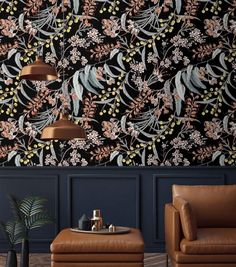 a living room with two leather chairs and a floral wallpaper