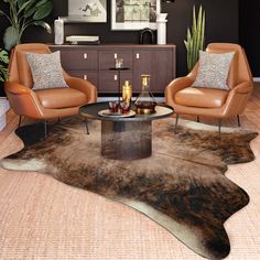 a living room with two chairs and a table in the middle of it, on top of a cowhide rug