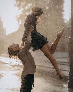 a man holding a woman on his back in the rain