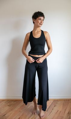 These pants are super flattering and fun to wear because of the gracefully flared leg. The fold-over waistband flattens the tummy, giving it a smooth look. Perfect for dressing up or casual wear. At the office, at the beach, yoga, and dancing. Made from a deliciously soft fabric with wonderful stretch and holds its shape well. This fabric is a very high-quality rayon lycra blend. Shown here in Black, paired with the Faith Strappy Woven Back Tank in Black. The Paris Flared Leg Pants are also available in Burgundy, Mocha, and Dark Teal. Great attention to detail when creating each item guarantees long-lasting wear. When properly cared for, these clothes remain beautiful year after year. Machine or hand wash cold delicate. Hang to dry. Flared Yoga Bottoms In Solid Color, Flare Yoga Bottoms, Chic Wide-leg Yoga Pants, Stretch Flare Pants With Elastic Waistband, Summer Stretch Wide Leg Elastane Pants, Stretch Flare Wide Leg Pants, Stretch Elastane Wide Leg Pants For Summer, Elastane Pants With Wide Waistband For Loungewear, Stretch Wide Leg Elastane Pants For Summer