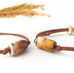 This unique, elegant hand crafted  ceramic bracelet made from stoneware clay and painted by hand with colorful mediterranean motifs.  Our ceramic bracelets are strung on an adjustable cotton cord and feature a single wooden or metal bead and it's perfectly adjustable as you wish. Dimensions 0.9 oz 6" min L - x 9" max L Each ceramic bracelet comes out of the kiln with slight differences, so when you order, there may be 5% differences about colors and tones of the product. Kiln fired to extremely high heat to add strength and durability. Artisan Bracelet With Sliding Knot As Gift, Artisan Bracelet With Sliding Knot For Gift, Adjustable Hand Painted Jewelry For Everyday, Adjustable Hand Painted Bracelets For Gift, Bracelets Unique, Ceramic Bracelet, Heart Themed, Metal Bead, Handmade Bracelet