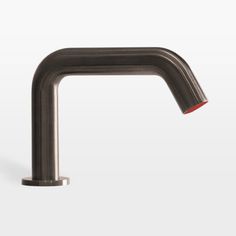 a metal faucet on a white background with red handles and nozzles