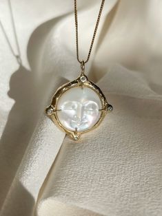 A dreamy 15mm hand-carved Mother of Pearl Moon encircled in gold, set with (4) White Diamonds, set on a solid 14k yellow gold 0.8mm box chain. (Approx. 5.7g.) Inspired in essence by the Impressionist French composer Claude Debussy, Clair de Lune translates to pale blue light or moonlight, and embodies the Divine Feminine energy of the moon, wholly encapsulating the deep sense of serenity found through inner self-awareness, and the strength kept within the gentleness of the heart. Aligns with int Soft Energy, Claude Debussy, Divine Feminine Energy, The Divine Feminine, Beacon Of Light, Self Awareness, Feminine Energy, Divine Feminine, Gold Set