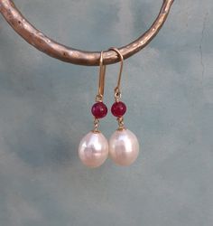 14k solid yellow gold pearl ruby dangle earrings These pearl earrings are made of  14k solid yellow gold with real ruby beads and white fresh water pearls.  Chic timeless statement eartings hand made with love and care💗 Measures: 💗total lengt: 1.4  inches approx 💗pearls: 10x 12mm approx 💗100% 14k solid gold hallmarked on ear wires 🌍Door to door registered shipping Big Pearl Earrings, Ruby Earring, Dangle Pearl Earrings, Earrings Big, Big Pearl, Ruby Beads, Gold Pearl Earrings, Ruby Earrings, Earrings Unique