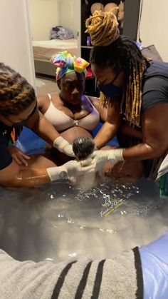 three women are doing something in the water