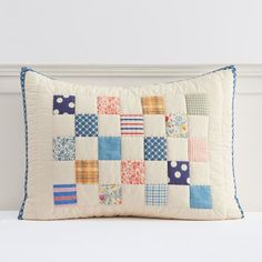 a white pillow with colorful patchwork on it