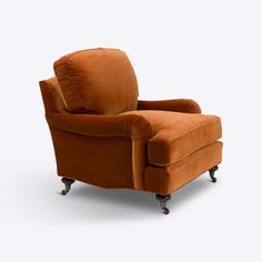 an orange chair sitting on top of a white floor