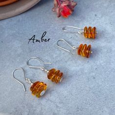 These Triple stacked Amber earrings have been handmade with sterling silver. Created in our Jewellery studio in Exeter, Devon.  Choose A or B Colour: Transparent Amber Finish: Polished Finish A: 39mm total length, 13mm wide - custom pin with a disc on the bottom and handmade ear hooks B: 36mm  total length, 13mm wide - Ball ended pin, handmade hooks Please check these measurements on a tape measure to ensure you are happy with the size of the earrings We do our best to represent the colors of ou Amber Sterling Silver Hypoallergenic Earrings, Hypoallergenic Sterling Silver Amber Earrings, Hypoallergenic Amber Sterling Silver Earrings, Minimalist Sterling Silver Amber Jewelry, Minimalist Amber Sterling Silver Jewelry, Exeter Devon, Jewellery Studio, Polished Pebble, Amber Earrings