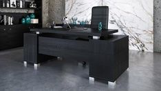 a black desk in an office with marble walls