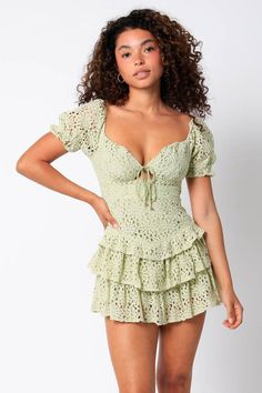 STYLE INFORMATION: All eyes will be on you in the Penelope Sage Lace Skort Dress! Sage eyelet fabric, shapes a sweetheart neckline, puff sleeves, and a ruffle-tiered mini skirt lined with shorts. Features front-tie detailing and fitted bodice. DETAILS & CARE: Cotton/Spandex. Machine Wash Cold. Imported. SHIPPING: We offer free shipping for all orders in the Continental US. Sage Lace Dress, Sage Green Mini Dress, Summer Going Out Outfit, Aesthetic Lookbook, Megan Moroney, Skort Dress, Dress Sage, Desired Reality, Tiered Mini Skirt