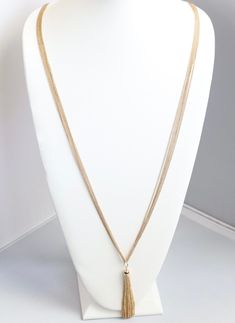 This long gold necklace is a great addition to any jewelry collection. It's a classic piece that will add a touch of elegance to any outfit. The necklace is made of high-quality gold and has a lobster claw clasp. Elegant 16 Inch Snake Chain Necklace, Formal Costume Jewelry With Adjustable Chain, Elegant Pendant Charm Necklace With Chain, Party Gold Snake Chain Necklace, Party Necklaces With Gold Snake Chain, Gold Necklace 16 Inch For Party, Elegant Necklace With Delicate Metal Chain, Party Necklace With Gold Snake Chain, Formal Long Necklace With Clavicle Chain