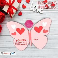 a valentine's day card with a pink butterfly and red heart shaped candy lollipop