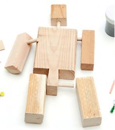 wooden blocks, pencils and other crafting supplies laid out on a white surface