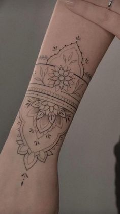 a woman's arm with a tattoo on it and a flower in the middle