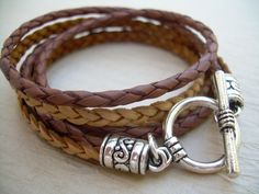 This triple wrap double strand leather bracelet is offered just in time for Fall. Wrap these rich strands of saddle brown and natural braids around your wrist and off you go! Materials: Lead and Nickel Free - Aged Silver Toned Alloy Metal Components, Fine Grade Imported 3 and 5 mm round and flat leather cords. Each piece comes with a brand hang tag and a black drawstring pouch. Size: Available to fit a firm wrist measurement of 6/6.5/7/7.5/8/8.5 inches. Need different length? Just ask! Wraps thr Vintage Brown Wrap Bracelet Gift, Vintage Brown Wrap Bracelet, Brown Leather Wrap Bracelet As Gift, Brown Leather Wrap Bracelet For Gift, Brown Leather Wrap Bracelet Gift, Brown Leather Strap Wrap Bracelet Gift, Brown Double Band Bracelet With Leather Strap, Brown Double Band Leather Bracelets, Brown Double Band Leather Strap Bracelets