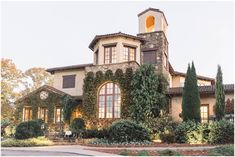 a large house with ivy growing on the side of it's roof and windows