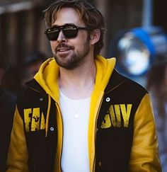 a man wearing sunglasses and a yellow jacket