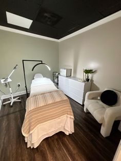 an empty bedroom with a bed, chair and desk in the corner next to it