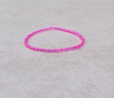 These are cute size 11/0 Japanese Transparent Hot Pink stretch seed bead bracelets! You'll receive one bracelet per transaction!  Stretch seed bead bracelets are made on elastic cord, so these bracelets stretch then slide over your hand! It's your choice of how you'd like your bracelets to fit based on your wrist size, and the size options given! (Please measure your wrist accordingly!) These seed beads are size 11/0 so they're super tiny, and the beautiful colors of the seed beads I use pack a punch! If you're unfamiliar with the size "11/0" the hole is the size of a needle point! (11/0 seed beads are 2mm by 2mm with the hole a diameter of 1mm.) Your bracelets will come shipped in an organza drawstring pouch! Bracelets Dainty, Needle Point, Bead Bracelets, Seed Bead Bracelets, Drawstring Pouch, Seed Bead, Seed Beads, Labour Day, Beautiful Colors