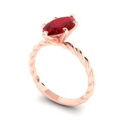 a rose gold ring with a red stone in the center and twisted band around it