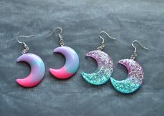 Dangle earrings with resin glitter moon and star pendants available in the foollowing options: 1. Pink/Purple/Blue Moons 2. Purple/Blue Glitter Moons Purple/Blue Glitter Moon & Star Purple/Blue Glitter Stars Please note that the colour distribution may vary slightly to the image shown. For other pastel items including the matching necklace click here: https://www.etsy.com/uk/shop/InfiniteRoseDesigns?ref=seller-platform-mcnav&section_id=23620397 For other celestial items in my shop click here:    https://www.etsy.com/uk/shop/InfiniteRoseDesigns?ref=seller-platform-mcnav&section_id=24328296 Thank you for visiting, for more items from InfiniteRoseDesigns, go to my shop: https://www.etsy.com/uk/shop/InfiniteRoseDesigns?ref=seller-platform-mcnav Handmade Moon-shaped Party Earrings, Handmade Moon Earrings For Party, Handmade Moon Shape Party Earrings, Kawaii Moon, Pet Artwork, Star Purple, Earrings Kawaii, Pastel Earrings, Pastel Kawaii