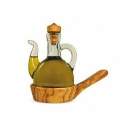 a bottle of olive oil sitting on top of a wooden spoon