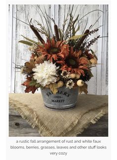 a bucket filled with lots of flowers sitting on top of a table