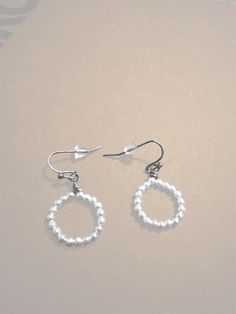 Add a touch of elegance to any outfit with these handcrafted pearl beaded hoop earrings. Perfect for both casual wear and special occasions, these earrings feature a delicate hoop design adorned with shimmering pearls. Lightweight and versatile, they make a timeless addition to your jewelry collection. Elegant Nickel Free Hoop Beaded Earrings, Elegant Nickel-free Hoop Beaded Earrings, Elegant Nickel-free Beaded Hoop Earrings, Elegant Beaded Sterling Silver Hoop Earrings, Elegant Beaded Teardrop Hoop Earrings, Elegant Small Hoop Adjustable Pearl Earrings, Elegant Adjustable Small Hoop Pearl Earrings, Elegant Small Hoop Beaded Single Earring, Elegant Teardrop Beaded Earrings For Everyday