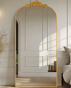 an ornate gold framed mirror in a white room