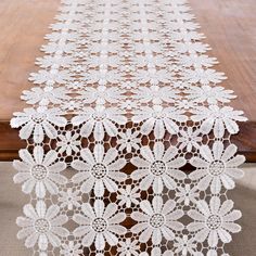 a table runner with white crocheted doily