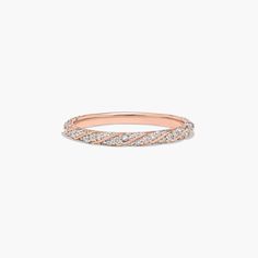 a rose gold band with white diamonds on the inside and outside, set against a plain background