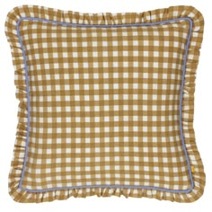 a brown and white checkered pillow with blue piping on the bottom, in front of