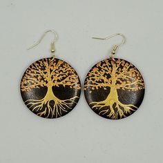 My earrings are made from maple wood and I paint them with iridescent acrylic paints.This pair of earrings has a tree design on it. The background wood is stained a dark brown and painted on top is a shimmery gold trunk with shimmery coppery leaves. The ear hooks and jump rings are made from gold plated surgical steel so you will not get any allergies!!!The approximate diameter of the wood is 4 cm / 1.5 inches. Handmade Wooden Gold Jewelry, Artistic Hand Painted Brown Earrings, Handmade Gold Wooden Jewelry, Gold Trunk, Iridescent Acrylic, Tree Design, Wood Earrings, Ear Hook, Tree Designs