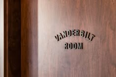 the name and logo are carved into the wood paneled walls in this hotel room