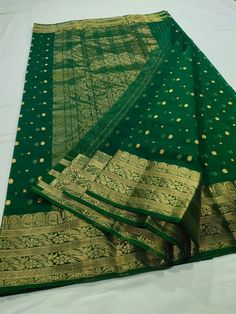 This Pure Chanderi Katan Silk Original in dark green with Single naal thousand buttis and a grand border and Aanchal is an absolute masterpiece. This is an authentic saree handwoven in the same weaving technique and style with which Anushka's beautiful saree was made. The Material, design, and quality are exactly the same as the one that Anushka wore to one of the most prestigious award ceremonies. The grandeur of this Saree makes it a perfect pick for ANY occasion. To see our entire Chanderi co Dark Green Bollywood Traditional Wear For Festive Season, Green Chanderi Saree For Wedding, Dark Green Bollywood Dupatta With Cutdana, Bollywood Style Dark Green Dupatta With Cutdana, Bollywood Style Dark Green Cutdana Dupatta, Dark Green Cutdana Traditional Wear For Festive Occasions, Dark Green Dupatta For Wedding And Festivals, Bollywood Style Dark Green Traditional Wear For Festivals, Dark Green Bollywood Traditional Wear For Festivals