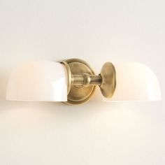 a bathroom light that has two lights on each side of the wall and one is off white