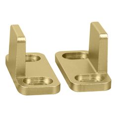 pair of brass plated metal brackets on white background