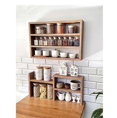 a wooden shelf filled with spices on top of a counter