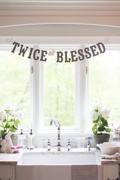 a kitchen sink under a bunting banner that says, twice bleeded on it