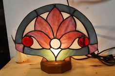 a stained glass lamp sitting on top of a wooden table