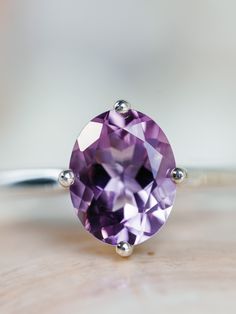 This classic compass style solitaire setting contains a beautiful 2.50ct. natural Rose De France amethyst. This unique setting has prongs in a north, south, east and west configuration. The oval cut stone measures approximately 9x7mm and the band is 2mm wide. The ring is available in sterling silver, and 14k white, yellow, or rose gold. This ring makes a unique promise or engagement ring. Please send me a message if you need a size not listed. * This ring can be customized with any color center Classic Oval Purple Gemstones, Classic Purple Oval Gemstones, Purple Oval Classic Gemstones, Classic Oval Amethyst Ring, Timeless Oval Purple Amethyst Ring, Timeless Purple Oval Amethyst Ring, Classic Oval Amethyst Ring With Prong Setting, Timeless Oval Amethyst Ring As Gift, Timeless Oval Amethyst Ring For Gift