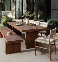 an outdoor dining table with benches and chairs