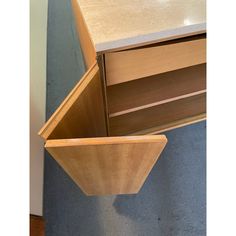 a wooden cabinet with two open drawers