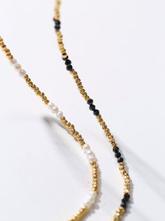 Experience the exquisite beauty of our handcrafted Black Spinel Gold Bean Mini Bead Necklace. Each element is carefully handcrafted to create a refined, elegant look. Add a touch of sophistication to any outfit with this versatile and glamorous necklace. Metal: 18ct Recycled Gold Plated On Brass Gemstone:Black Spinel Pearl: Freshwater Pearl 2.5mm Length: 400-450mm Weight: 5g Elegant Pearl Necklace With Gold Beads, Elegant Gold Beaded Necklace With Tiny Beads, Elegant Yellow Gold Beaded Necklace, Elegant Pearl Necklace With Tiny Beads, Elegant Gold Pearl Necklace With Tiny Beads, Elegant Pearl Beaded Necklace With Gold Beads, Black Spinel Necklace, Black Spinel, Recycled Gold