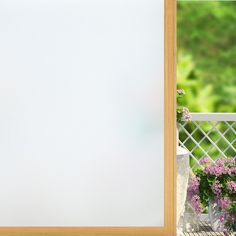 an open door with flowers and potted plants outside