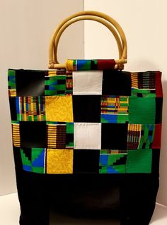 "Kente Cloth Bag | 100% Cotton and Vinyl Bag | Oversized Handbag | Boho Bag | Handcrafted Block Bag | Weekend Bag | Handmade | Gift When boho, traditional African fabric and vinyl meet, the combination is magical. These two textures have created this oversized handbag that is durable, reusable, and eye-catching. Along with the \"D-Shape\" handles and large inner pocket the bag is perfect for any occasion. Excited to introduce you all to my new \"Oversize Bag Collection. Handmade in a SMOKE-FREE Green Rectangular Bucket Bag For Gifts, Rectangular Green Bucket Bag As A Gift, Green Rectangular Bucket Bag As Gift, Rectangular Hobo Bag With Leather Handles, Multicolor Top Handle Bags, Multicolor Pouch Box Bag For Daily Use, Eco-friendly Black Shoulder Bag With Removable Pouch, Eco-friendly Pouch Shoulder Bag With Leather Handles, Multicolor Square Bucket Bag For Daily Use